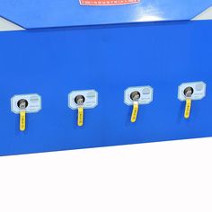 four yellow handles on a blue and white box with three different buttons in the middle