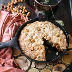 a skillet with a piece taken out of it and some nuts on the side