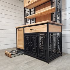 a black and wood cabinet sitting on top of a hard wood floor