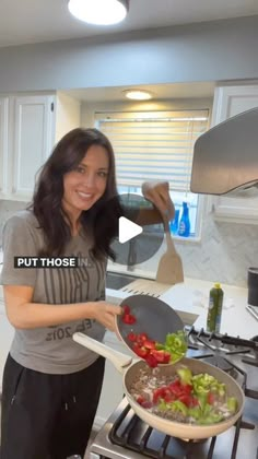 a woman is cooking vegetables in a pan on the stove