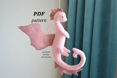 a pink stuffed animal hanging from a string with the words pdf pattern below it