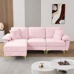 a living room with a pink couch and coffee table