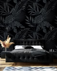 a bedroom with black wallpaper and an upholstered bed in front of it