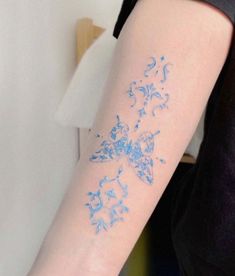 a woman's arm with blue ink on the left side of her arm,