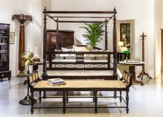 a bedroom with four poster bed and wooden furniture