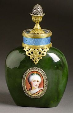 an ornate green vase with a portrait on it