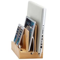 a cell phone, tablet and laptop in a wooden holder