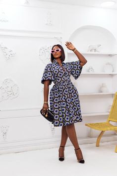 This LALA African Print Flare Sleeve Button Dress is sure to add a lil' va-va-voom to your wardrobe! Its high-quality fabric, fierce pocket detailing, and 'Oh-so-fabulous' flared sleeve make it the perfect fit for any stylish slay queen! Add your favorite slides and a mini bag for a legendary look – we guarantee you won't regret it! FEATURES. 100% African Wax Cotton Dress is Unlined Flare sleeves Button-down at the front. Matching belt Collar neckline Side pockets Model Is Wearing a Medium Dress Fit And Flare Ankara Dress, Cotton Stylish Dresses, Flare Sleeves Dress, Wax Dress African, Bitenge Fashions For Ladies, African Shirt Dresses For Women Classy, Flared Dresses Classy, Modern Ankara Dress Styles, Ankara Flare Dress Styles