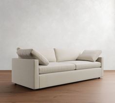 a white couch sitting on top of a wooden floor