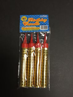 four red and yellow plastic darts in packaging