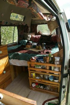 the inside of a van with an open bed and storage drawers on the back wall