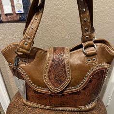 Offered For Your Consideration Is This Cute Tan Colored Western Style Purse Made By Montana West. It Comes To Your Home As Brand New With Tags (Msrp $130)!. Gorgeous Saddle Brown Color With Rivets And Shoulder Straps Making It Easy To Carry And Stylish! Convenient Easy-Access Carry Conceal/Phone Pocket Keeps Your Personal Protection Devise Or Phone Close At Hand Yet Stylishly Out Of Sight! Three Nice Sized Pockets (One Zipped) And One Small Inside Pocket (Zipped) For Lot's Of Storage And Magneti Khaki Tote Bag, Western Bags, Western Style Purse, Montana West Purse, Montana West Handbags, Concealed Carry Bags, Camo Purse, Western Bag, Leather Fringe Bag