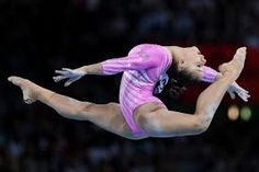 a woman is performing on the balance beam