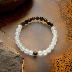 Elevate your energy with this 6mm faceted Tigers Eye & Selenite stretch bracelet  Promote peace, grounding, protection, mental clarity, emotional healing, abundance and an over all sense of well being with this beautiful crystal beaded bracelet.   Each bracelet is handmade with love and intention. Custom orders available with personalization upon request Small - 6.5" (tiny wrist)  Medium - 7" (avg women)  Large - 7.5" (avg men) XI - 8" (avg L wrist men)  XXL - 8.5"(XXL men) White Spiritual Beaded Bracelets For Meditation, White Gemstone Beads Stretch Bracelet For Meditation, White Faceted Crystal Bracelet Spiritual Style, White Faceted Crystal Bracelet, Spiritual Style, White Hypoallergenic Crystal Bracelet For Meditation, Hypoallergenic White Crystal Bracelet For Meditation, Faith Healing, Intention Bracelets, Healing Gemstone Bracelets