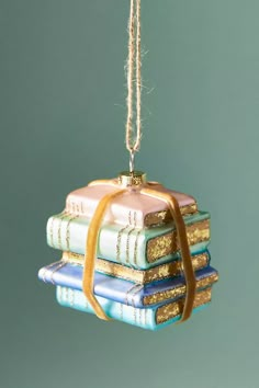 a stack of books hanging from a string