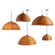 three wooden pendant lights hanging from the ceiling