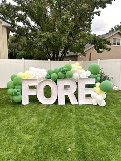 Green, white, and yellow balloons surrounding white marquee letters saying fore. Four Year Old Golf Party, Golf Fourth Birthday Party, Golf 4th Birthday Party, Boy Fourth Birthday Party Ideas, Fore Birthday Theme, Foam Board Numbers, Boy 4th Birthday Party Themes