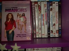 there are many dvd's on the shelf in this room, including meangirls