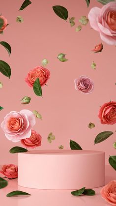 pink and orange roses are falling from the top of a white cake stand on a pink background