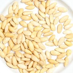 a white plate topped with peanuts on top of a table