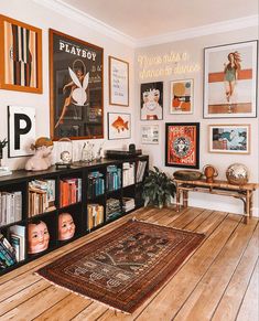 a room filled with lots of books and pictures on the wall next to a wooden table