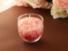 a small glass bowl filled with marshmallows on top of a brown table