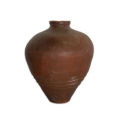 a large brown vase sitting on top of a white surface