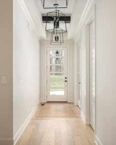 the hallway is clean and ready to be used as an entrance way for someone's home