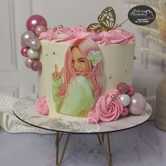 a birthday cake decorated with pink and white frosting