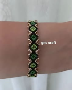 a woman wearing a bracelet with green beads on her arm and the words gnc craft above it