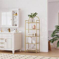 a bathroom with white walls and gold shelving next to a plant on the counter