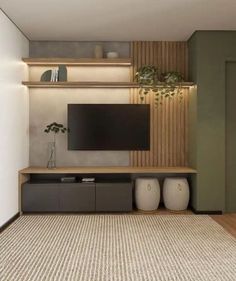 a living room filled with furniture and a flat screen tv on top of a wooden shelf