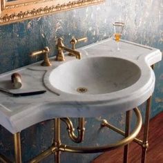 a bathroom sink sitting under a mirror next to a painting