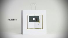 an open white box with the words education on it and a video playing button inside