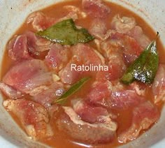 a white bowl filled with meat and vegetables