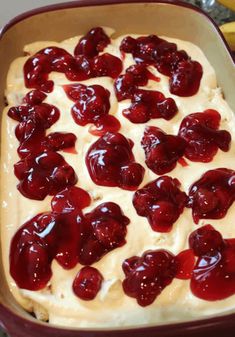 a dish with cream and cherries in it