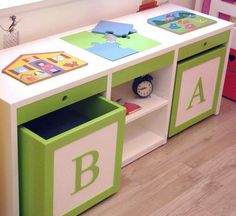 a green and white children's play table with letters on it, including the letter b