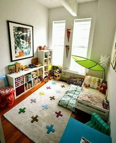 a child's bedroom with lots of toys and decor on the floor, including bookshelves