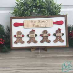 a wooden sign that says the reed family with four gingerbread men and one woman