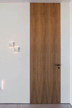 the door is made of wood and has three square lights on each side of it