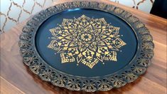 a decorative blue and gold plate on a wooden table