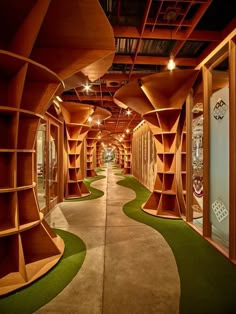 the inside of a store with wooden shelves and green carpeted flooring on both sides