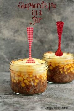 two jars with food in them and one has a red spoon sticking out of it