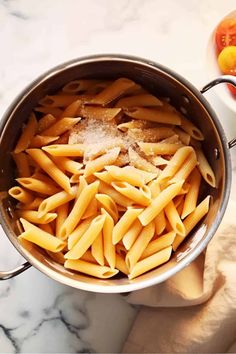 a pot filled with pasta next to tomatoes