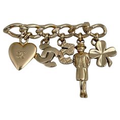 This is a charm bar brooch designed by Chanel for 2002 collection. The piece is gold plated. It features heart, CC logo, number five, madame Coco, clover charms. Signed: ©Chanel® 02P. Made in France Bar length: 6cm Width (at max): 4.5cm ——— If you have any questions, please feel free to ask. We describe our items accurately. Please note that in reality they can look much better because photo can’t capture that magical sparkle. We have many years of experience in this business. And we have a very Chanel Charm, Successful Family, Charm Bar, Logo Heart, Number Five, Bar Brooch, Character Board, Logo Number, David Webb