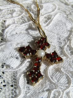 "9 Kt. gold cross set with garnets and a simulated pearl in the center, suspended from a 14 Kt. gold Singapore-style fancy 18-inch chain. This cross measures 1 inch tall by 3/4 of an inch wide. It is in excellent condition. The cross has Hallmarks for \"375\" or 9 Kt. gold, Birmingham, England and 1994. The chain is marked \"14 Kt.\" and \"Italy.\"" 20th Birthday Party, Chain Gang, Cross Gold, Necklace Christian, Red Sparkle, Birmingham England, Gold Cross Necklace, Silver Jewels, Jewelry Lookbook