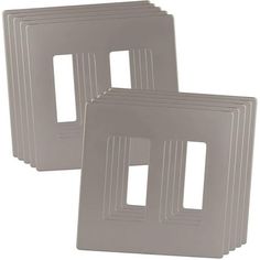 four square metal plates with white lines on each side and one in the middle, all facing different directions