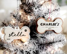 personalized dog ornament hanging from a christmas tree with silver tinsel on it