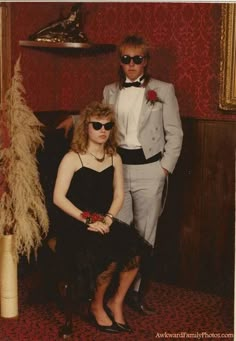 a man and woman dressed up in formal wear