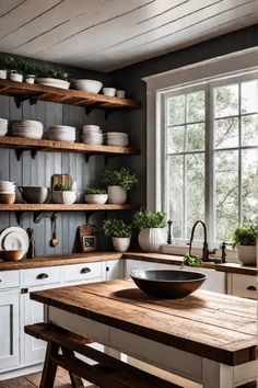 a kitchen filled with lots of white dishes and wooden shelves next to a large window